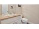 This half-bath boasts neutral walls, ample counter space, and a modern toilet at 24317 E Powers Ave, Aurora, CO 80016