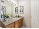 Well-lit bathroom featuring a large mirror, neutral countertop, and stylish décor at 12338 W Dorado Pl # 305, Littleton, CO 80127