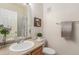 Bathroom featuring a single sink vanity, toilet, framed art and shower with curtain at 12338 W Dorado Pl # 305, Littleton, CO 80127