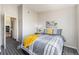 Cozy bedroom featuring a gray and white plaid bedspread, complemented by a yellow throw at 12338 W Dorado Pl # 305, Littleton, CO 80127