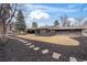 Expansive backyard with stone pathway, dark mulch, and large lawn extending to the house's exterior at 456 Cherry Street, Denver, CO 80220