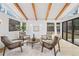 Living room with four chairs and a round table, complemented by hardwood floors and natural light at 456 Cherry Street, Denver, CO 80220
