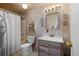 Bathroom featuring white-washed paneling, a shower/tub combo, and a single vanity at 10826 Livingston Dr, Northglenn, CO 80234