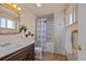 Bathroom with a single vanity, tiled floors, a shower/tub combo, and a linen closet at 10826 Livingston Dr, Northglenn, CO 80234