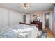 Bedroom featuring hardwood floors, a floral-patterned bedspread, and mirrored closet doors at 10826 Livingston Dr, Northglenn, CO 80234