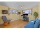 Bedroom featuring hardwood floors, a ceiling fan, and multiple windows providing ample natural light at 10826 Livingston Dr, Northglenn, CO 80234