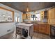 Well-lit kitchen with wood cabinets, an island, an eat-in area, and a unique metal-patterned ceiling at 10826 Livingston Dr, Northglenn, CO 80234