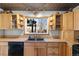 Kitchen featuring wood cabinets, modern appliances, a sink overlooking the backyard, and custom ceiling at 10826 Livingston Dr, Northglenn, CO 80234