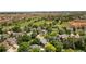 Aerial view of homes in a residential neighborhood with a park, ball field and construction nearby at 2249 Weatherstone Cir, Highlands Ranch, CO 80126