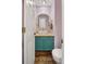 Stylish half bathroom with a vessel sink, modern fixtures, and a round mirror at 2249 Weatherstone Cir, Highlands Ranch, CO 80126
