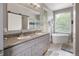 Bright bathroom with dual vanity, soaking tub, tiled shower and plenty of natural light at 2249 Weatherstone Cir, Highlands Ranch, CO 80126