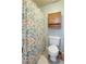 Bathroom featuring a patterned shower curtain, toilet, and upper cabinet at 2249 Weatherstone Cir, Highlands Ranch, CO 80126