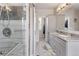 Ensuite bathroom includes double sinks, walk-in glass shower and a linen closet at 2249 Weatherstone Cir, Highlands Ranch, CO 80126