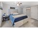 Well-lit bedroom with a comfortable queen-sized bed and soft carpeted floors at 2249 Weatherstone Cir, Highlands Ranch, CO 80126