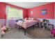 Bedroom featuring colorful walls, a comfortable bed, and natural light from the window at 2249 Weatherstone Cir, Highlands Ranch, CO 80126