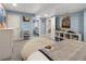 Cozy bedroom with gray carpet, a comfortable bed, and cheerful blue walls at 2249 Weatherstone Cir, Highlands Ranch, CO 80126
