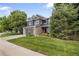 Attractive two-story home with a well-kept lawn, stone accents and a two-car garage at 2249 Weatherstone Cir, Highlands Ranch, CO 80126