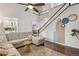 Open-concept living room featuring vaulted ceilings, staircase and hardwood floors at 2249 Weatherstone Cir, Highlands Ranch, CO 80126