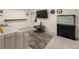Spacious living room with a large TV, modern furnishings, and a stylish gray rug at 2249 Weatherstone Cir, Highlands Ranch, CO 80126