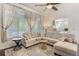 Bright living room with vaulted ceilings, windows with drapes, and a plush sectional at 2249 Weatherstone Cir, Highlands Ranch, CO 80126