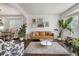 Bright living room featuring a modern couch, area rug, decor and hardwood floors at 2249 Weatherstone Cir, Highlands Ranch, CO 80126