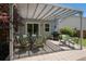Backyard patio with elegant outdoor dining set, a grill, and a charming pergola for al fresco gatherings at 7871 Ogden Ct, Denver, CO 80229