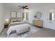 Stylishly furnished bedroom with ceiling fan, soft rug, and modern decorative accents at 7871 Ogden Ct, Denver, CO 80229