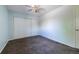 Cozy bedroom featuring neutral carpet, a ceiling fan, and sliding door closet at 7871 Ogden Ct, Denver, CO 80229