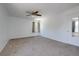 Spacious bedroom featuring a ceiling fan, soft carpet, and a window at 7871 Ogden Ct, Denver, CO 80229