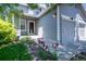 Charming home exterior featuring a well-manicured lawn and beautiful flower beds along the front walkway at 7871 Ogden Ct, Denver, CO 80229
