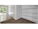 Hallway with access to the sliding glass door and adjacent to built-in shelving at 7871 Ogden Ct, Denver, CO 80229