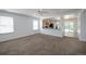 Open living room featuring plush carpet and a view of the kitchen with granite countertops at 7871 Ogden Ct, Denver, CO 80229