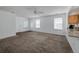 Living room with plush carpet and a view of the kitchen with granite countertops at 7871 Ogden Ct, Denver, CO 80229