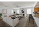 Bright living room featuring modern furniture, large windows, and hardwood flooring at 7871 Ogden Ct, Denver, CO 80229
