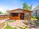 Backyard features a wooden structure, a stone patio, and green grass at 3015 N Fillmore St, Denver, CO 80205