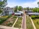 Bungalow-style home featuring a xeriscaped front yard, quaint porch, and a brick drive, city views in the background at 3015 N Fillmore St, Denver, CO 80205