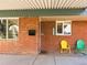 Cozy front porch with painted brick, colorful seating, and welcoming facade. Address is marked at 3015 N Fillmore St, Denver, CO 80205