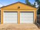 Detached two-car garage with white doors and exterior lights at 3015 N Fillmore St, Denver, CO 80205