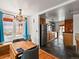 Open layout with hardwood floors leading to the kitchen featuring stainless steel appliances at 3015 N Fillmore St, Denver, CO 80205