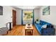 Bright living room features hardwood floors, large windows, and comfortable blue sofa at 3015 N Fillmore St, Denver, CO 80205