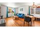 Open concept living space with hardwood floors, large windows, and stylish chandelier at 3015 N Fillmore St, Denver, CO 80205