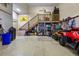 Spacious garage with storage loft, stairs, and ample room for vehicles and recreational equipment at 6398 Lost Canyon Ranch Rd, Castle Rock, CO 80104