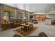 Bright living room showcasing large windows, plush seating, and an open layout connected to the kitchen at 6398 Lost Canyon Ranch Rd, Castle Rock, CO 80104