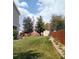 Lush green backyard with a fence, providing a private oasis for relaxation and enjoyment at 11821 W Independence Ave, Lakewood, CO 80401