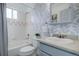 Bathroom featuring decorative wall paper, a vanity, and a shower-tub combo at 11821 W Independence Ave, Lakewood, CO 80401