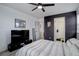 Bedroom featuring a dark accent wall, sleek furniture, and view into the ensuite bathroom at 11821 W Independence Ave, Lakewood, CO 80401