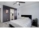 Modern bedroom with a ceiling fan, stylish decor, and an attached ensuite bathroom at 11821 W Independence Ave, Lakewood, CO 80401