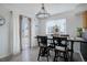 Bright dining space with a view to the backyard and modern light fixture at 11821 W Independence Ave, Lakewood, CO 80401