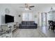 Stylish living area with couch, ceiling fan, and bright natural light at 11821 W Independence Ave, Lakewood, CO 80401