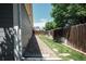 Side yard with rocks and grass, features partial fence and nice landscaping at 18656 E Harvard Dr, Aurora, CO 80013